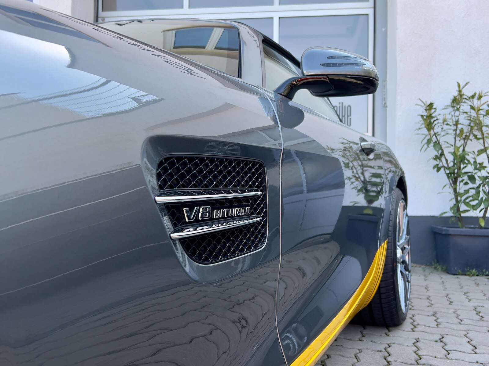 Mercedes-AMG GT in Anthrazit mit spiegelglatter Lackfläche und V8 Biturbo Kotflügel-Detail im Neowash-Studio in Braunschweig — Premium-Keramikversiegelung mit tiefer Reflexion